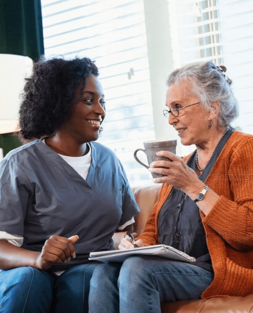 Caregiver helping elderly woman